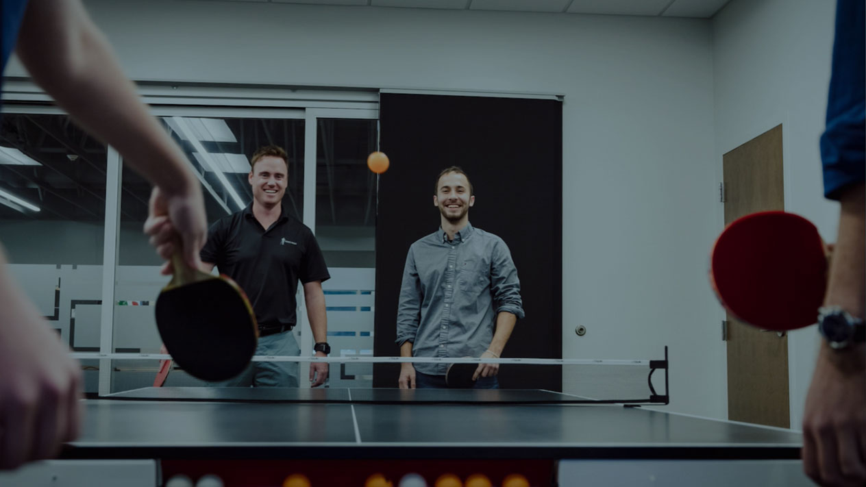 OWN employees playing table tennis.